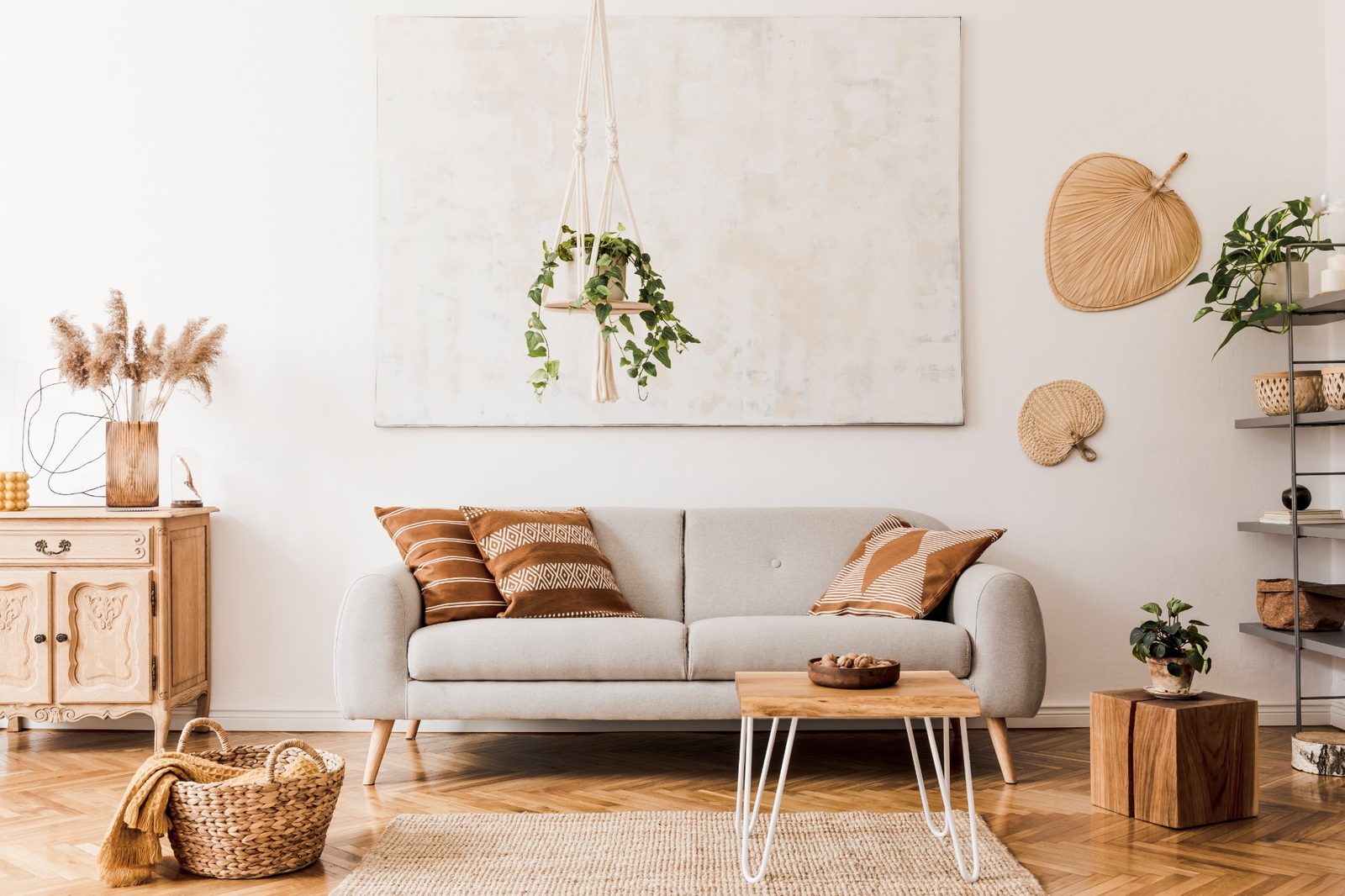 Warm neutral living room with a linen sofa, woven textures and plants